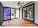 Enclosed sunroom with wood floors and large sliding windows offers relaxing views of the surrounding landscape at 1015 Chapman Ln, Stone Mountain, GA 30088