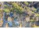 Aerial view of property surrounded by lush greenery, trees, and foliage on a sunny day at 916 Marshall Fuller Rd, Dallas, GA 30157