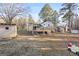 View of the backyard with a wooden deck, shed, and ample space for recreation at 916 Marshall Fuller Rd, Dallas, GA 30157