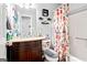 Bathroom features granite vanity, updated fixtures, and a shower with a patterned curtain at 916 Marshall Fuller Rd, Dallas, GA 30157