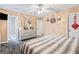 Bedroom with ceiling fan, ensuite bath, dresser, and plenty of natural light at 916 Marshall Fuller Rd, Dallas, GA 30157