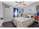 Cozy bedroom with a ceiling fan and a patterned comforter set in a well lit home at 916 Marshall Fuller Rd, Dallas, GA 30157