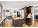 Open kitchen with wood cabinets, stainless steel refrigerator, and view of the dining area at 916 Marshall Fuller Rd, Dallas, GA 30157