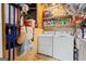 Bright laundry room with a washer and dryer unit, as well as shelving for storage at 916 Marshall Fuller Rd, Dallas, GA 30157