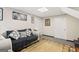 Finished basement living room with a neutral colored sofa and decorative rug at 916 Marshall Fuller Rd, Dallas, GA 30157