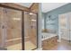 Bathroom featuring a tile shower with glass door and a soaking tub with stone surround at 968 Hines Rd, Moreland, GA 30259