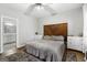 This cozy bedroom features hardwood floors, ceiling fan, and white dresser with a wood headboard at 9209 W Banks Mill Rd, Winston, GA 30187
