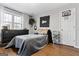 This room features a comfortable bed, ample natural light, stylish decor, and hardwood floors at 9209 W Banks Mill Rd, Winston, GA 30187