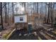 View of a wooden chicken coop enclosed in the forest with a small window at 9209 W Banks Mill Rd, Winston, GA 30187