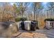 Wooden deck featuring two grills surrounded by lush trees creates an ideal outdoor cooking and gathering space at 9209 W Banks Mill Rd, Winston, GA 30187