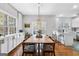 Charming dining room with hardwood floors, light fixture, and natural light through a window at 9209 W Banks Mill Rd, Winston, GA 30187