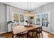 Bright dining room featuring a large window and modern chandelier at 9209 W Banks Mill Rd, Winston, GA 30187