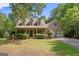 Charming home with a welcoming front porch, well-manicured landscaping, and a two-car garage with basketball hoop at 9209 W Banks Mill Rd, Winston, GA 30187
