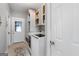 Clean laundry room with white cabinets, modern washer and dryer and tile flooring at 9209 W Banks Mill Rd, Winston, GA 30187