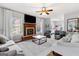 Bright living room featuring a fireplace with wooden mantle, fan, hardwood floors and natural light at 9209 W Banks Mill Rd, Winston, GA 30187