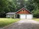 Charming home with a two-car garage, wood, and stone elements at 9091 Woodgreen Way, Jonesboro, GA 30238
