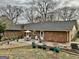 Backyard featuring a patio with dining set, surrounded by landscaping and mature trees at 365 Jordan Dr, Tucker, GA 30084