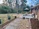 Lush backyard with stone pathway and patio, ideal for outdoor gatherings and relaxation at 365 Jordan Dr, Tucker, GA 30084