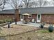 Relaxing patio with dining set and landscaped garden beds, perfect for outdoor entertaining at 365 Jordan Dr, Tucker, GA 30084