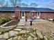 Backyard with a concrete patio, outdoor dining set, manicured garden beds and mature landscaping at 365 Jordan Dr, Tucker, GA 30084