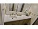 Bathroom vanity with decorative flowers and neutral color scheme, complemented by black and white patterned tile flooring at 365 Jordan Dr, Tucker, GA 30084