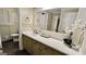 Bathroom vanity with decorative flowers and neutral color scheme, complemented by black and white patterned tile flooring at 365 Jordan Dr, Tucker, GA 30084