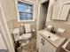 Neutral bathroom with a single sink vanity, updated fixtures, and a window for natural light at 365 Jordan Dr, Tucker, GA 30084
