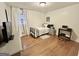 Well-lit bedroom featuring a bed with nightstand and workstation with hard wood floors and natural light at 365 Jordan Dr, Tucker, GA 30084