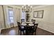Dining room with dark wood table and chairs, chandelier, and wainscoting at 365 Jordan Dr, Tucker, GA 30084