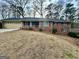 Charming brick home with a cozy front porch and a well-manicured lawn at 365 Jordan Dr, Tucker, GA 30084