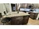 Stylish kitchen featuring a large island with granite countertop, seating, and dark wood cabinetry at 365 Jordan Dr, Tucker, GA 30084