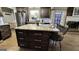 Kitchen with stainless steel refrigerator, an island with seating, and a partial view of a fireplace at 365 Jordan Dr, Tucker, GA 30084
