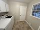 Functional laundry room with washer, dryer, cabinets, and natural light at 365 Jordan Dr, Tucker, GA 30084