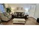 Comfortable living room with brown leather sofa, armchair, and large houseplant at 365 Jordan Dr, Tucker, GA 30084