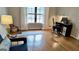 Bright living room featuring hardwood floors, a yoga mat, a large window, and stylish blue chair at 365 Jordan Dr, Tucker, GA 30084