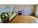 Inviting living room with stylish green sofa, blue chair, and gleaming hardwood floors at 365 Jordan Dr, Tucker, GA 30084