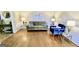 Inviting living room with stylish green sofa, blue chair, and gleaming hardwood floors at 365 Jordan Dr, Tucker, GA 30084