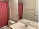 Bathroom with tub, toilet, and vanity with sink and mirror at 4019 Pin Oak Trl, Decatur, GA 30034