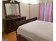 Bedroom with a wooden dresser, mirror, and a comfortable bed at 4019 Pin Oak Trl, Decatur, GA 30034
