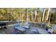 Relaxing back deck area with outdoor seating and beautiful views of the surrounding natural forest at 220 Joe Dr, Temple, GA 30179