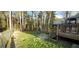 Backyard featuring mature trees and a wooden deck, offering a private outdoor space at 220 Joe Dr, Temple, GA 30179