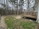 Spacious backyard featuring a multi-level deck overlooking a treelined property at 220 Joe Dr, Temple, GA 30179