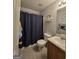 Cozy bathroom featuring a shower with curtain, toilet, vanity with sink, and neutral wall paint at 220 Joe Dr, Temple, GA 30179