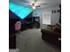 A bedroom with blue accent wall and a unique lighting fixture at 220 Joe Dr, Temple, GA 30179
