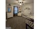 Bedroom features a crib, rocking chair, dresser, and ceiling fan at 220 Joe Dr, Temple, GA 30179