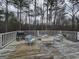Wooden deck showcasing an outdoor seating area with a grill and tree-lined background at 220 Joe Dr, Temple, GA 30179