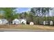Charming single-Gathering home with a well-maintained lawn and a storage shed in a wooded neighborhood at 220 Joe Dr, Temple, GA 30179
