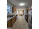 A second view of the kitchen with stainless steel refrigerator and a view into the dining room at 220 Joe Dr, Temple, GA 30179