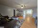 Open-concept living room featuring hardwood floors, a ceiling fan, and neutral paint scheme at 220 Joe Dr, Temple, GA 30179
