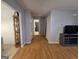 View from the living room showing hardwood floors, an open doorway, and an adjacent hallway at 220 Joe Dr, Temple, GA 30179